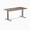 Desky Zero fixed height office desk with natural walnut laminate top, grommets, and space gray steel frame.