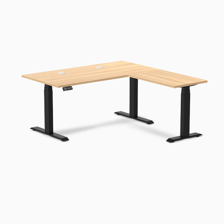 Desky L-Shape Laminate Sit Stand Desk in Sublime Teak with Matte Black frame and grommets.