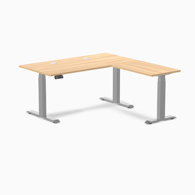 Desky L-Shape Laminate Sit Stand Desk in Sublime Teak with gray frame and grommets.