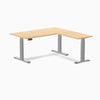 Desky L-Shape Laminate Sit Stand Desk in Sublime Teak with gray frame and grommets.