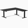 Black Desky L-Shape Laminate Sit Stand Desk with grommets and matte black frame.