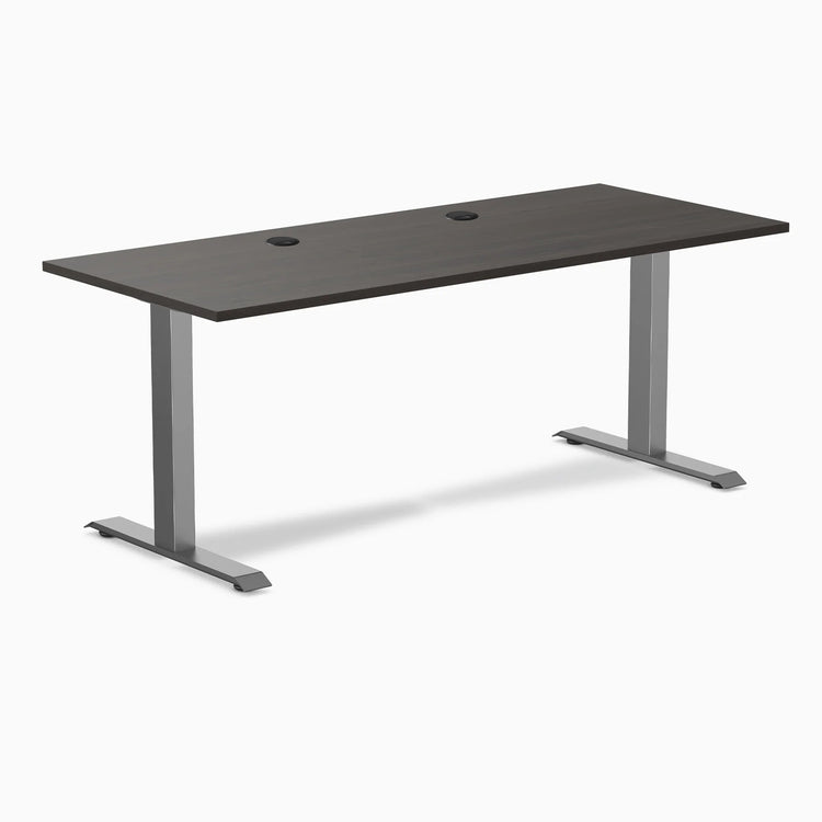 Desky Zero fixed height office desk with burnished wood laminate top, grommets, and space gray steel frame.