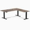 Desky L-Shape Laminate Sit Stand Desk in Natural Walnut with matte black legs and grommets.