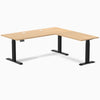 Desky L-Shape Laminate Sit Stand Desk in Sublime Teak with Matte Black frame and grommets.