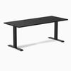 Desky Zero black laminate office desk, 70.9 x 29.5 inches, with two grommets and matte black steel frame.
