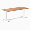 Desky Zero fixed height office desk with Prime Oak laminate top, white steel frame, and two grommets.