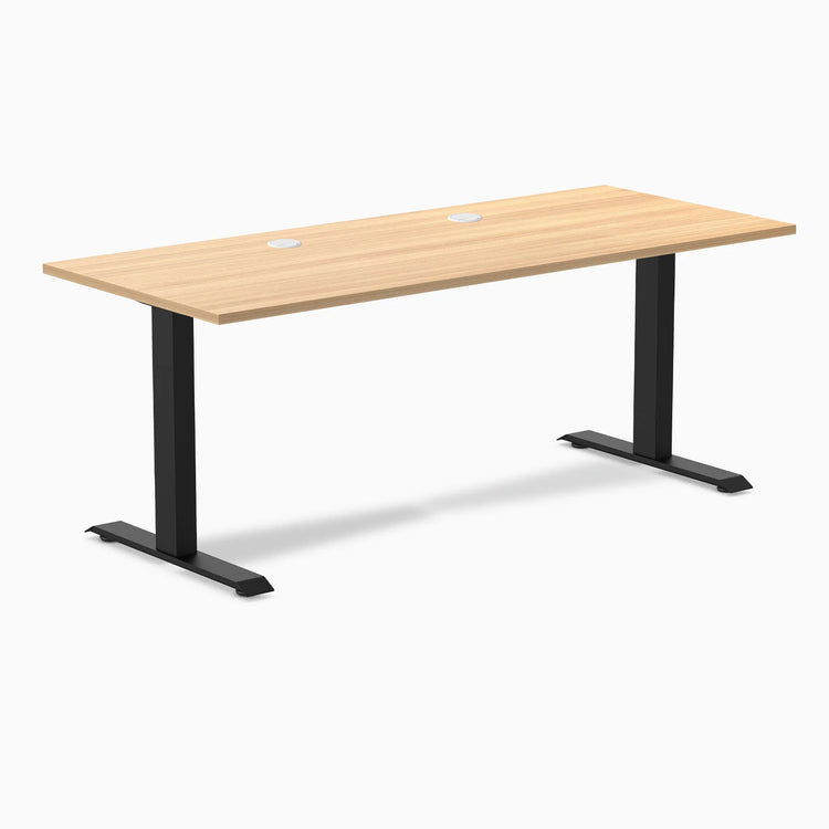 Desky Zero fixed height office desk with Sublime Teak laminate top, 70.9x29.5 inches, grommets, and matte black steel frame.