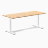 Desky Zero fixed height office desk with Sublime Teak laminate top, white steel frame, and two grommets.