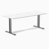 Desky Zero fixed height office desk with white laminate top, space gray steel frame, and two grommets.