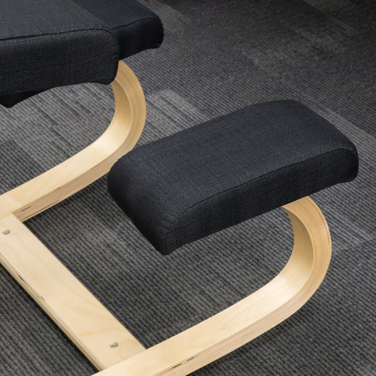 Desky ergonomic kneeling chair with black mesh cushions and a sleek beechwood frame on gray carpet.