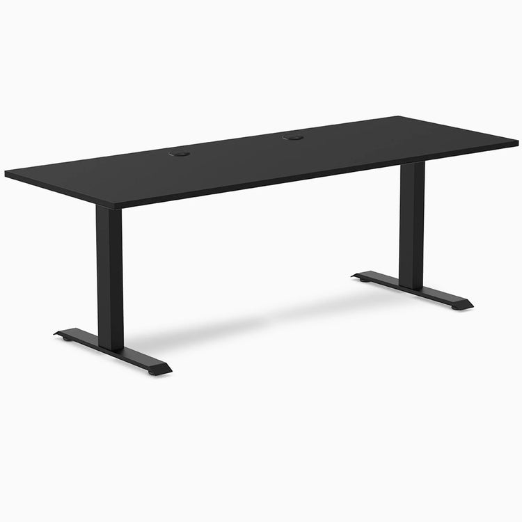 Desky Zero fixed height office desk with a matte black laminate top, steel frame, and two grommets.
