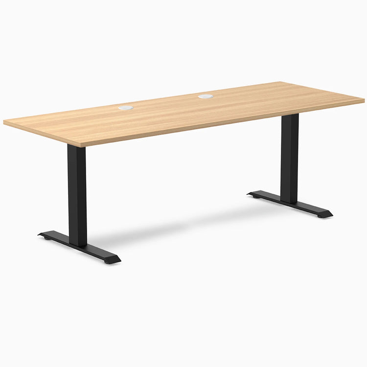 Desky Zero fixed height office desk with Sublime Teak laminate top, two grommets, and matte black steel frame.