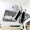 White Desky Expandable Laptop Mount holding a silver MacBook on a dual monitor arm setup.