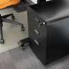 Black steel Desky 3-drawer mobile filing cabinet with rounded edges, key in lock, next to an office chair.