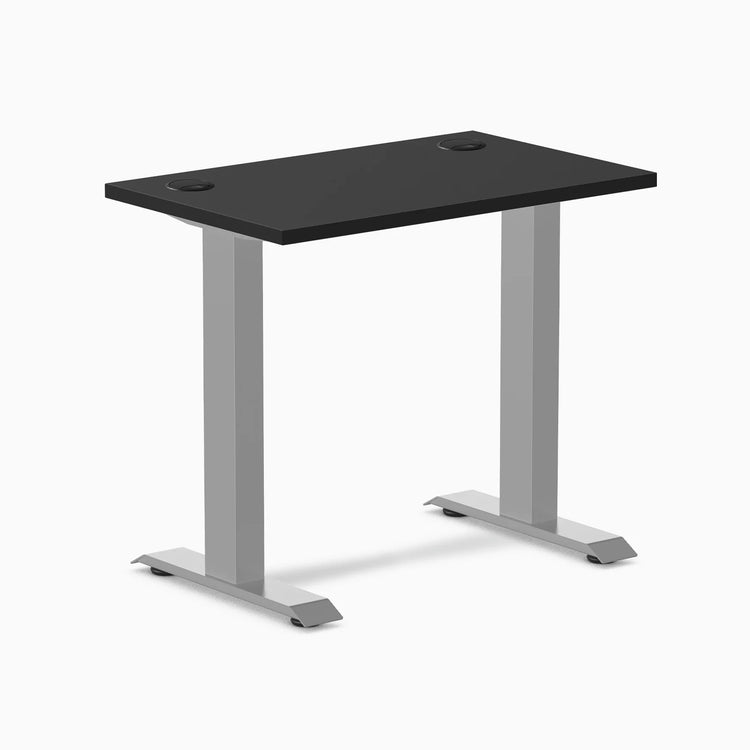 Desky Zero Mini fixed-height desk with black 32x20 inch top, grommets, and gray legs.
