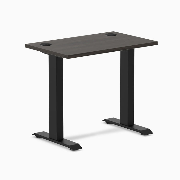 Desky Zero Mini sit-stand desk with burnished wood top, matte black legs, and grommets.