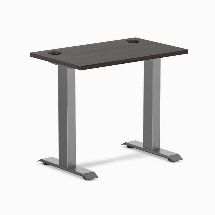 Desky Zero Mini sit-stand desk, burnished wood top with grommets, space gray legs.
