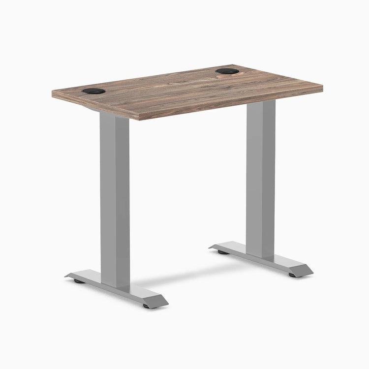 Desky Zero Mini desk with natural walnut top, gray fixed-height legs, and two grommets.