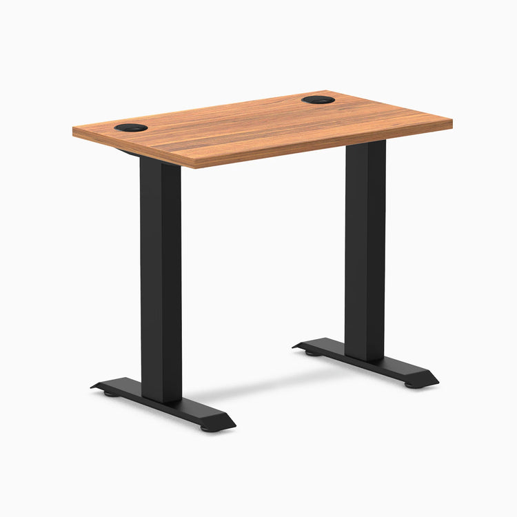 Desky Zero Mini sit-stand desk, Prime Oak 32x20 inch top with grommets, matte black fixed legs.