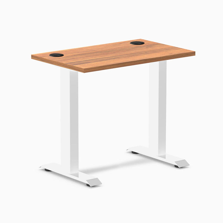 Desky Zero Mini fixed-height desk with Prime Oak top, white legs, and black grommets.