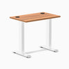Desky Zero Mini fixed-height desk with Prime Oak top, white legs, and black grommets.