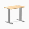 Desky Zero Mini sit-stand desk, Sublime Teak 32x20 inch top with grommets, gray legs.