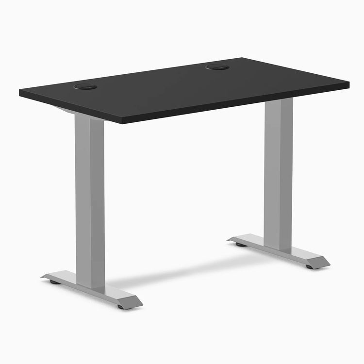 Desky Zero Mini fixed-height desk with black top, gray legs, and two grommets.