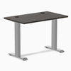 Desky Zero Mini sit-stand desk with burnished wood top, gray legs, and grommets.