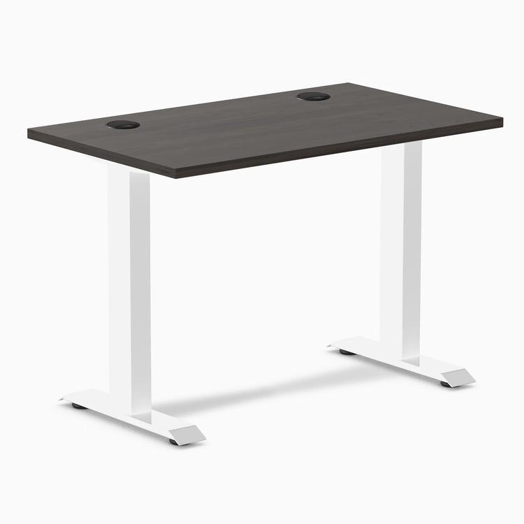 Desky Zero Mini fixed-height desk with burnished wood top, white legs, and two grommets.