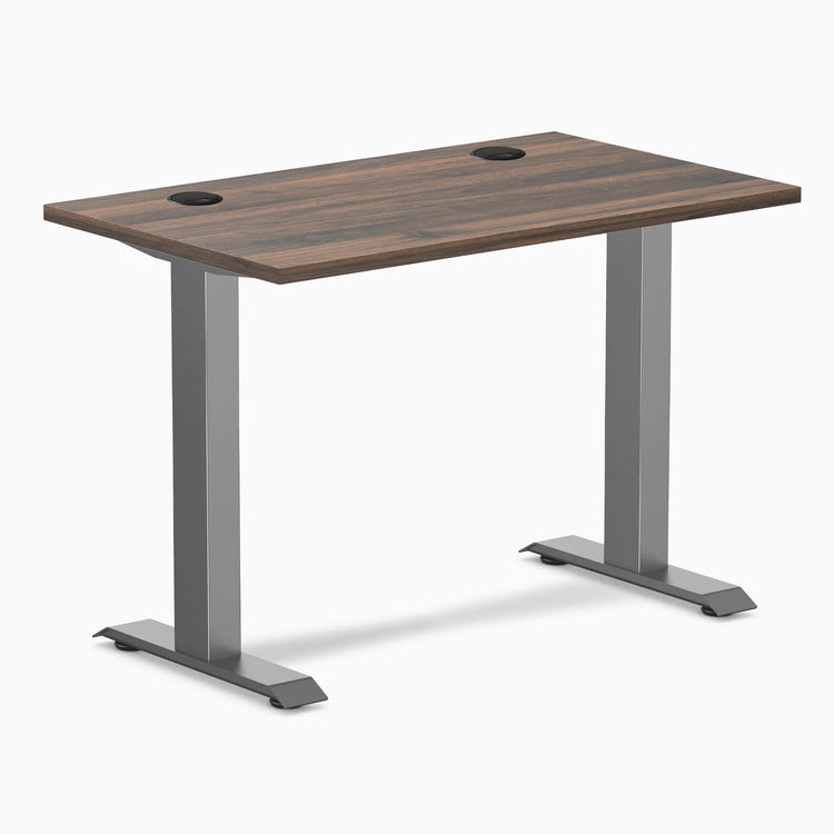 Desky Zero Mini fixed-height desk with Jarrah Legno top, Space Gray legs, and two grommets.