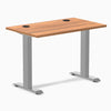 Desky Zero Mini fixed-height desk with Prime Oak top, gray legs, and two black grommets.