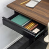 Black steel Desky Under Desk Drawer, open to reveal a green notebook and pens, mounted under a dark wood desk.