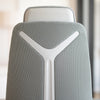 Close-up of Desky Pinnacle Executive Office Chair's light grey mesh backrest with white honeycomb structure and headrest.