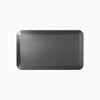 Black rectangular anti-fatigue standing mat with a rugged surface and bevelled edges.