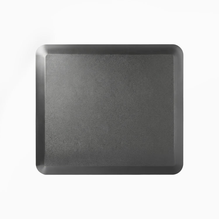 Black Desky anti-fatigue standing mat, 33.5x29.5 inches, with a rugged surface and bevelled edges.