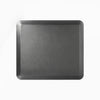 Black Desky anti-fatigue standing mat, 33.5x29.5 inches, with a rugged surface and bevelled edges.