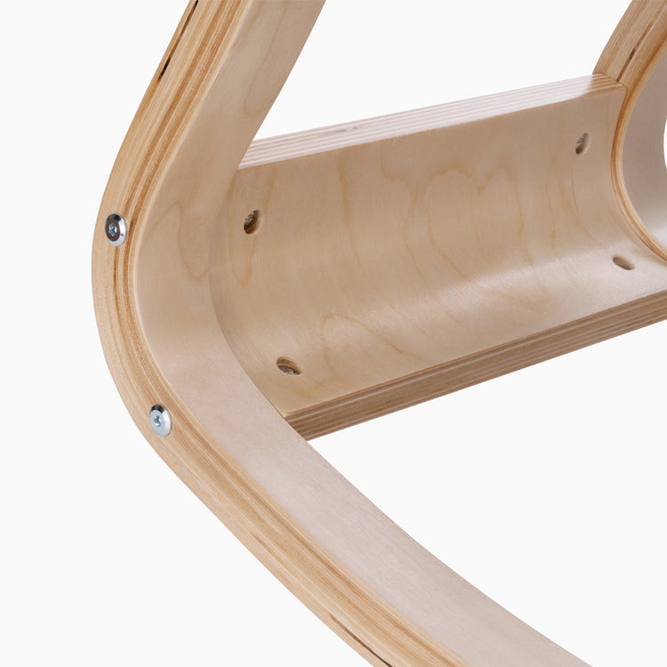 Close-up of a light beechwood kneeling chair frame with visible wood grain and silver screws.