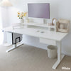 White Desky Dual Laminate Sit Stand Desk with monitor, keyboard, and accessories in a bright office.