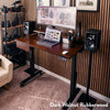 Desky Dual Rubberwood Sit Stand Desk in dark walnut with black adjustable frame, monitor, laptop, and speakers.