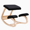 Desky Kneeling Chair with light beechwood frame and black mesh cushions.