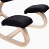 Desky ergonomic kneeling chair with black mesh cushions and a light beechwood frame.