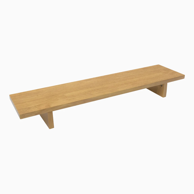 Desky Minimal Monitor Stand in light oak rubberwood, a sleek, long wooden riser with two simple supports.