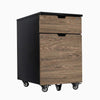 Desky black filing cabinet with two laminate natural walnut drawers, one lockable, on casters.