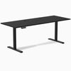 Black Desky Single Sit Stand Desk, 78.7 x 29.5 inches, with two grommets and control panel.