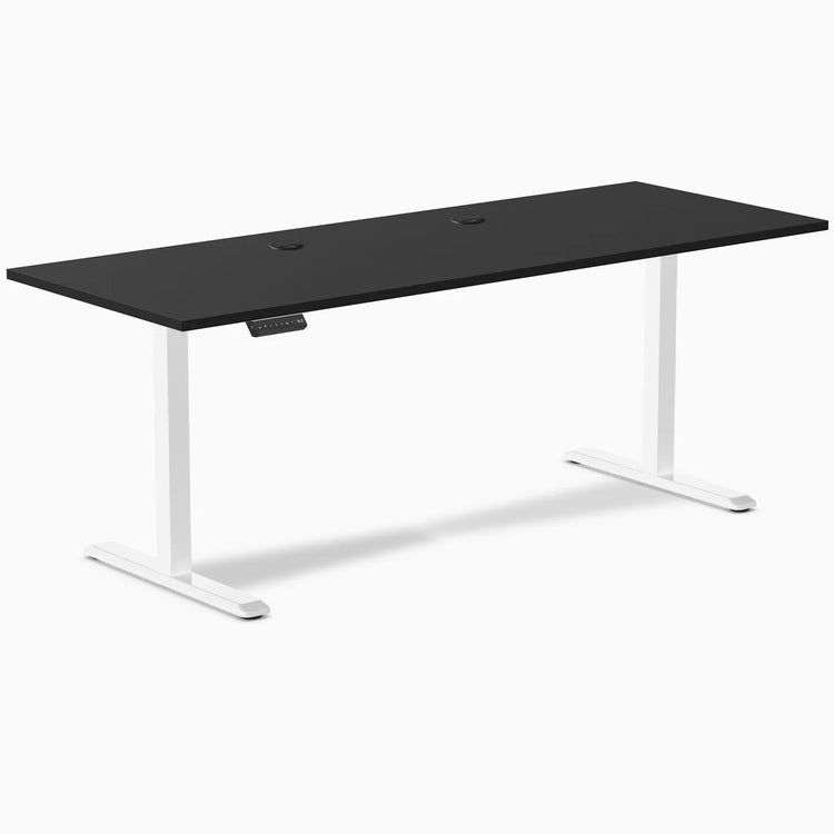 Black 78.7 x 29.5 inch Desky sit-stand gaming desk with white legs and two grommets.
