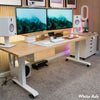 White Ash Desky Dual Hardwood Sit Stand Desk with dual monitors, speakers, and mobile storage.