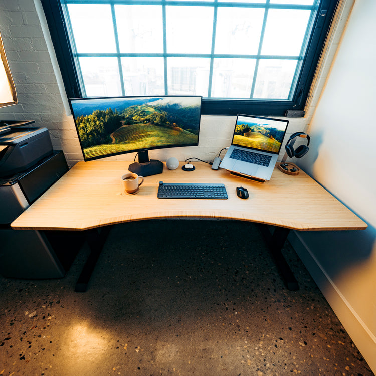 Desky Zero Ergo Edge Office Desk with a bamboo top, chamfered edge, and black steel frame.