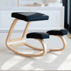 Desky ergonomic kneeling chair with light beechwood frame and black mesh cushions.