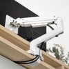 White Desky Heavy Duty Ultrawide Monitor Arm clamped to a light wood desk, with cables managed.