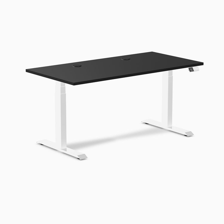 Black laminate sit-stand desk with white frame, two grommets, and digital control panel.